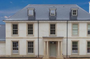 House front with cast stone portico and window cills
