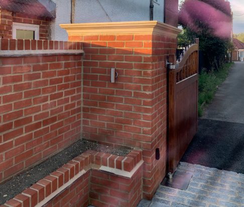 cast stone pier cap on top of brick wall